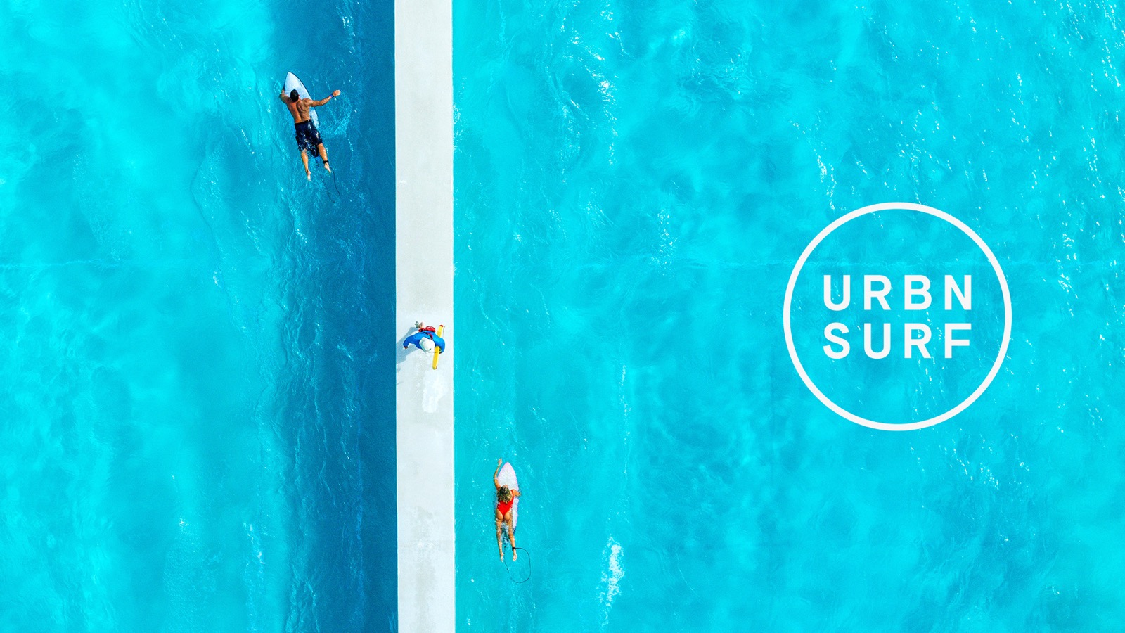 URBN SURF wave pool — aerial view of surfers in the pool alongside the URBN SURF logo